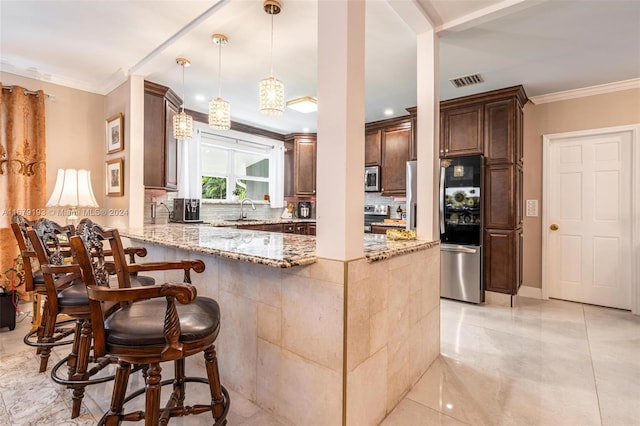 kitchen featuring appliances with stainless steel finishes, kitchen peninsula, light stone counters, and hanging light fixtures