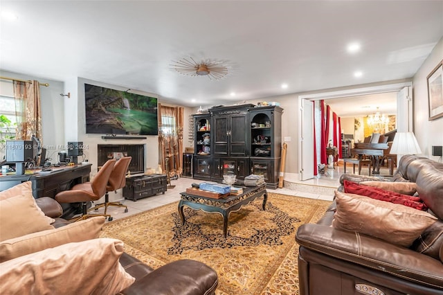 tiled living room with a notable chandelier