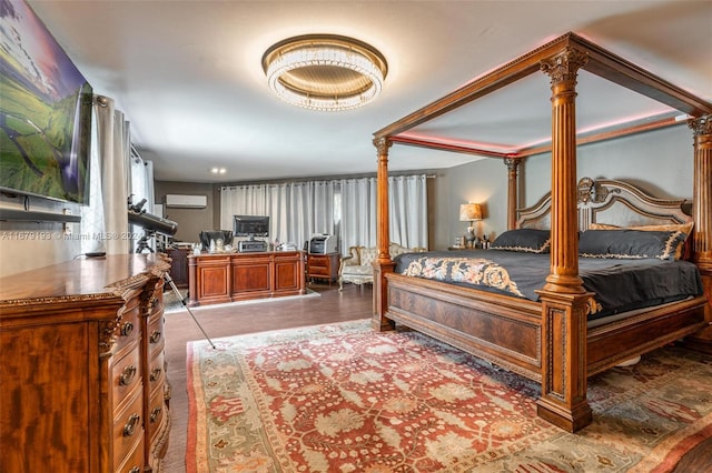 bedroom with decorative columns and a wall mounted AC