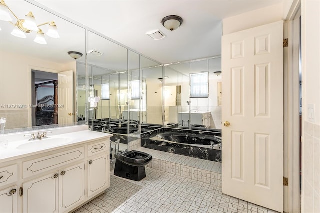 bathroom featuring tile walls, vanity, tile patterned flooring, and a bathing tub