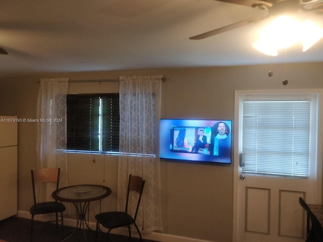 interior space with ceiling fan