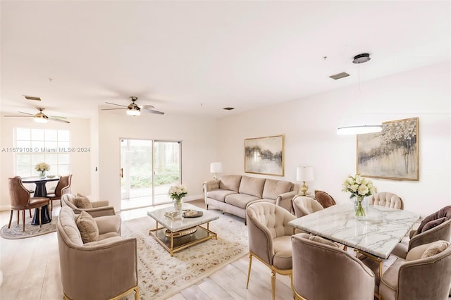 living room featuring ceiling fan and light hardwood / wood-style floors