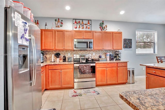 3544 W 94th St, Hialeah, FL 33018 - kitchen featuring appliances with stainless steel finishes, decorative backsplash, light stone countertops, recessed lighting, and light tile patterned flooring