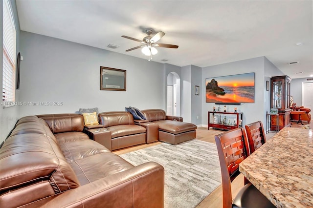 3544 W 94th St, Hialeah, FL 33018 - living room with arched walkways, a ceiling fan, and light wood-style floors