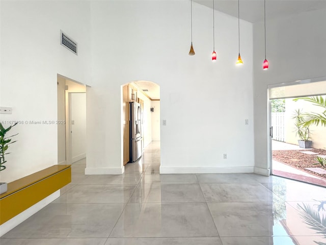 unfurnished room featuring a high ceiling