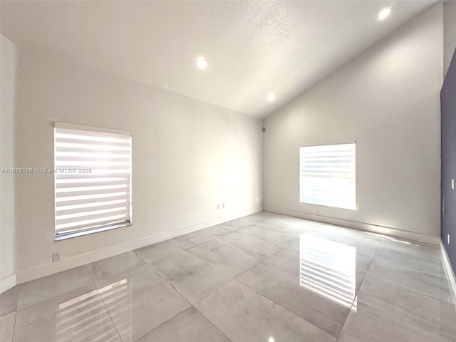 empty room featuring lofted ceiling