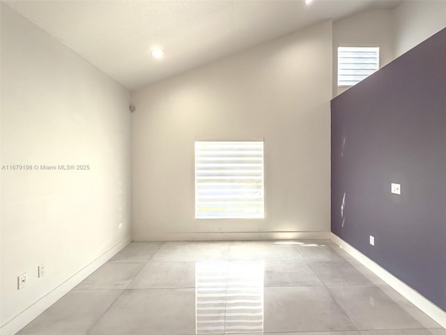 spare room featuring vaulted ceiling