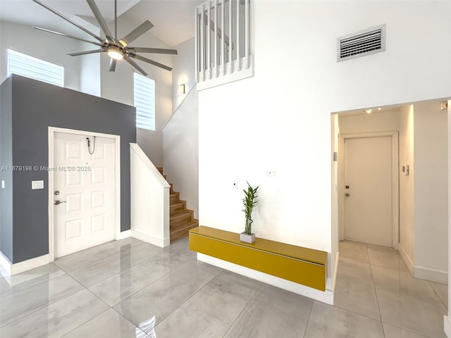 entryway with high vaulted ceiling, ceiling fan, and plenty of natural light