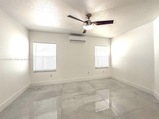 unfurnished room with a textured ceiling, ceiling fan, plenty of natural light, and a wall mounted air conditioner