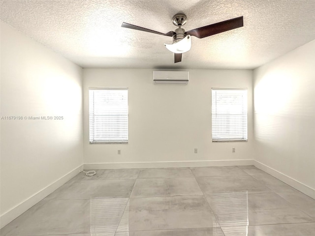 unfurnished room with an AC wall unit, ceiling fan, and a textured ceiling