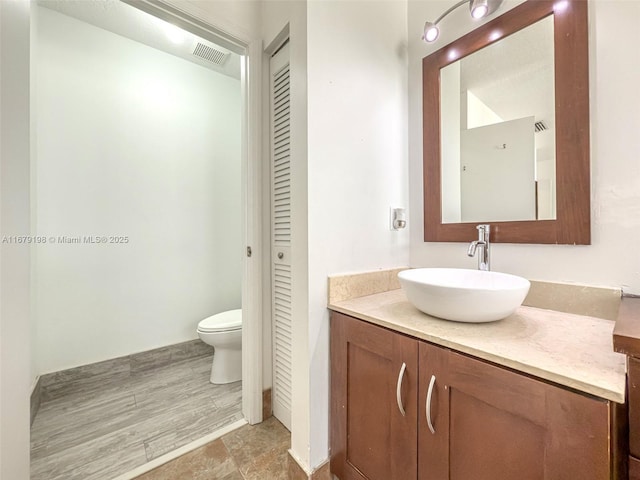 bathroom with vanity and toilet