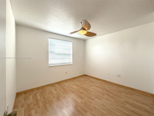 empty room with light wood-type flooring, ceiling fan, and a textured ceiling