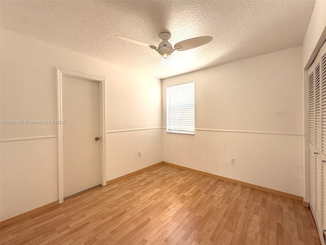 unfurnished bedroom with a closet, a textured ceiling, ceiling fan, and light hardwood / wood-style floors