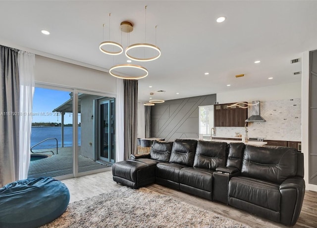 living room with a water view and hardwood / wood-style flooring