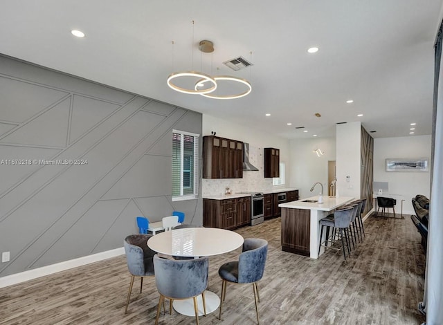 dining area with hardwood / wood-style flooring and sink