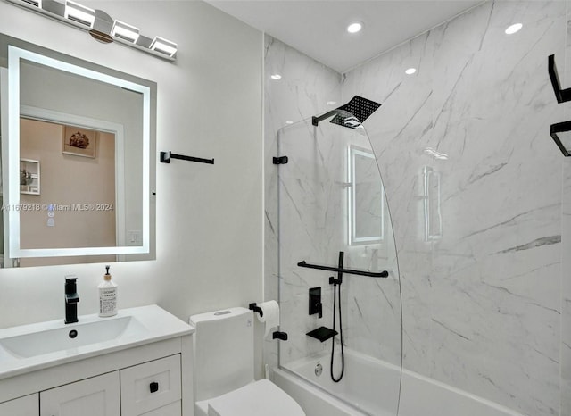 full bathroom with vanity, tiled shower / bath, and toilet