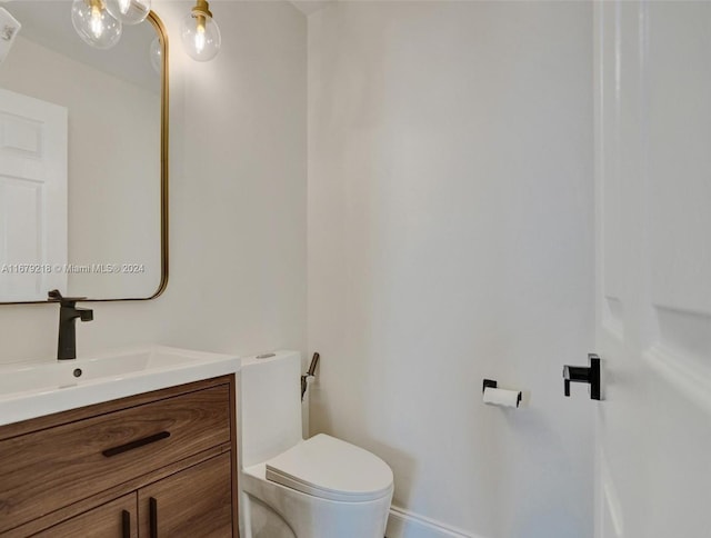 bathroom with toilet and vanity