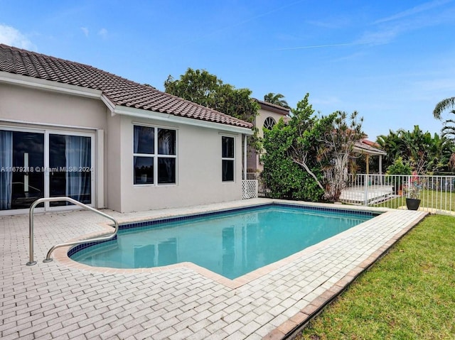 view of swimming pool featuring a patio area