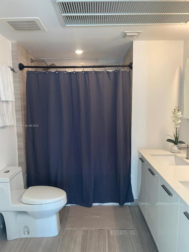 bathroom featuring vanity and toilet