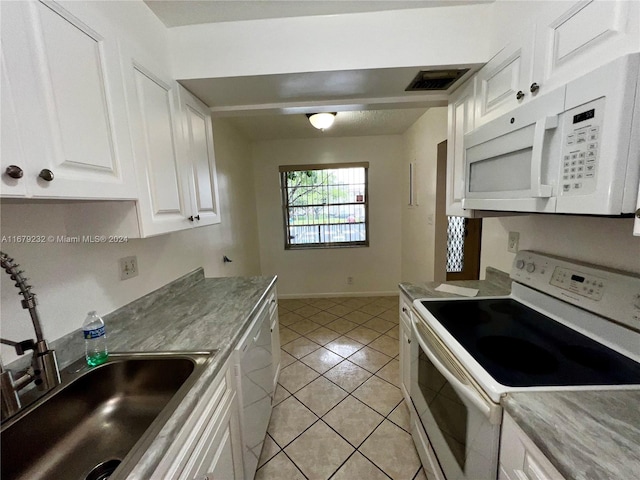 kitchen with sink, white cabinets, white appliances, and light tile patterned flooring