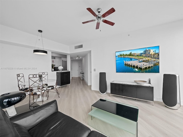 living room featuring hardwood / wood-style floors and ceiling fan