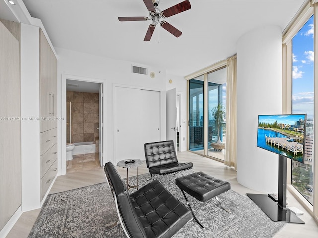 sitting room with light hardwood / wood-style flooring and ceiling fan