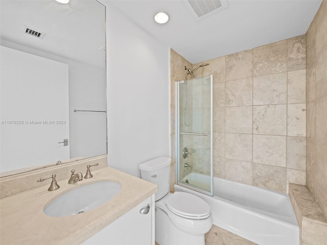 full bathroom featuring vanity, toilet, and tiled shower / bath combo