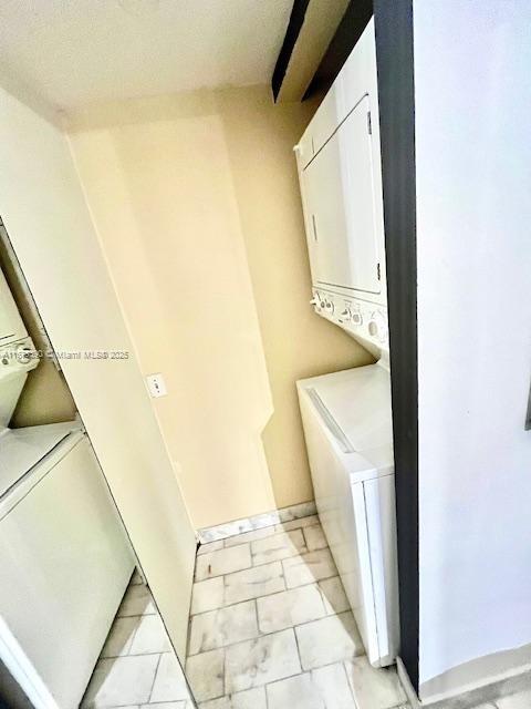 laundry room featuring stacked washer / dryer