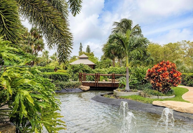 view of home's community with a water view and a gazebo