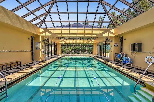 view of swimming pool with glass enclosure