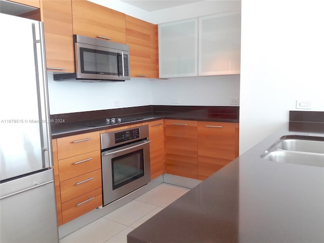 kitchen with stainless steel appliances and light tile patterned floors