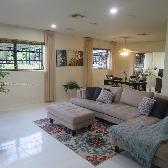 tiled living room with ceiling fan