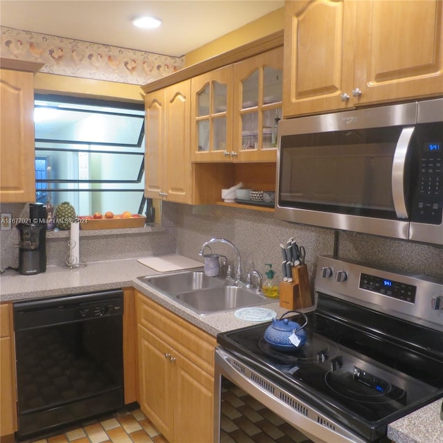 kitchen with light brown cabinetry, sink, appliances with stainless steel finishes, and backsplash