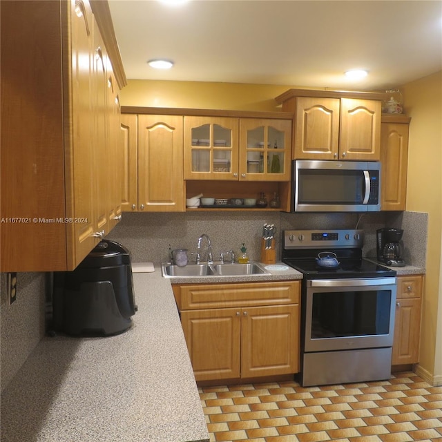 kitchen featuring sink, stainless steel appliances, and backsplash