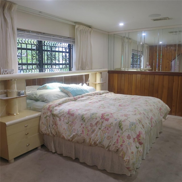 bedroom with crown molding and light colored carpet