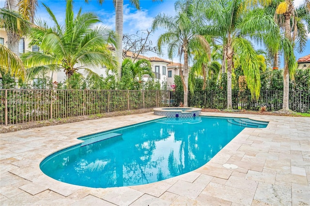 view of swimming pool with an in ground hot tub and a patio area