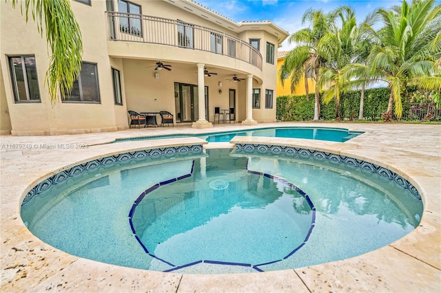 view of pool featuring an in ground hot tub, a patio, and ceiling fan