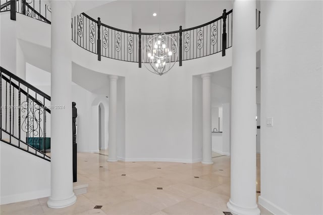 entryway with a high ceiling and a notable chandelier