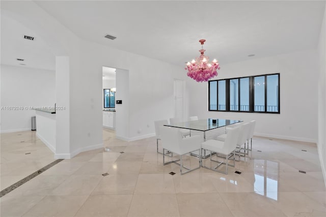 unfurnished dining area featuring a notable chandelier