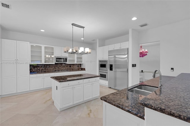 kitchen featuring appliances with stainless steel finishes, sink, and white cabinets