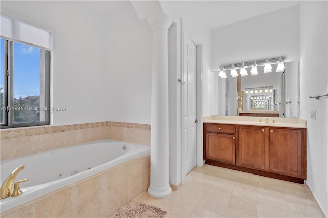 bathroom featuring vanity, a relaxing tiled tub, a healthy amount of sunlight, and tile patterned floors