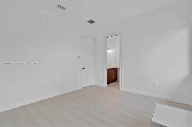 unfurnished room with light wood-type flooring