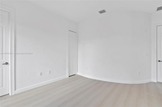 spare room with light hardwood / wood-style flooring