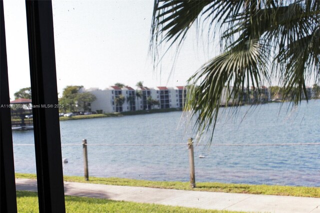 view of pool featuring a patio and a water view