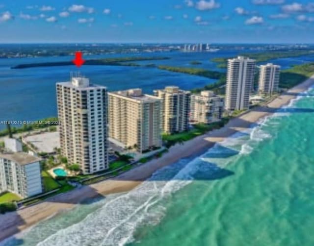 aerial view featuring a water view and a beach view