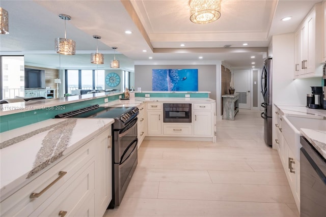 kitchen featuring light stone countertops, appliances with stainless steel finishes, white cabinetry, decorative light fixtures, and ornamental molding