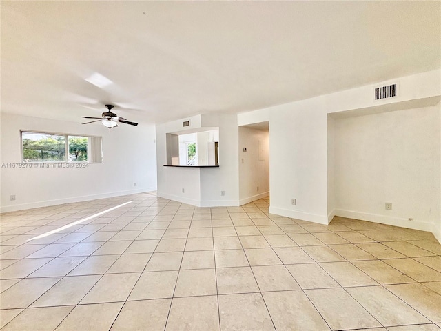 tiled empty room with ceiling fan