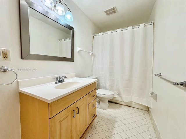 bathroom featuring vanity, toilet, curtained shower, and tile patterned flooring