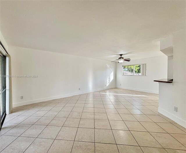 3405 NW 44th St Unit 104, Oakland Park, FL 33309 - unfurnished room featuring ceiling fan, light tile patterned floors, and baseboards