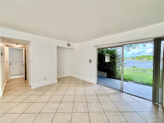 3405 NW 44th St Unit 104, Oakland Park, FL 33309 - unfurnished room with light tile patterned floors, a water view, and baseboards